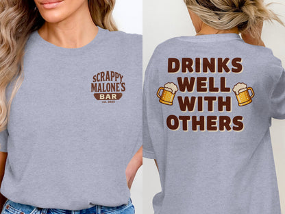 Drinks Well With Others Funny Party Social Graphic T-Shirt T-shirt - Scrappy Malone's Bar 100-Proof Humor - Cloud 16 Clothing Co.