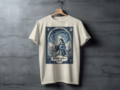 Cream t-shirt with "Weird Girls Club" and celestial art design.