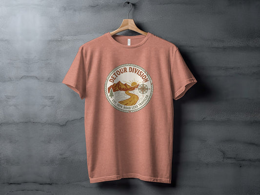 Detour Division Heritage | Vintage Outdoor Apparel: Round graphic on rust-colored t-shirt with mountains, sun, and compass, "Detour Division Est. 1974".