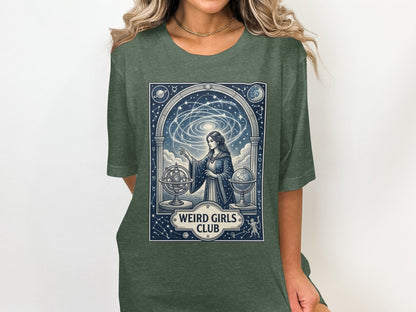 Woman wearing a green t-shirt with a celestial design and "Weird Girls Club" text.