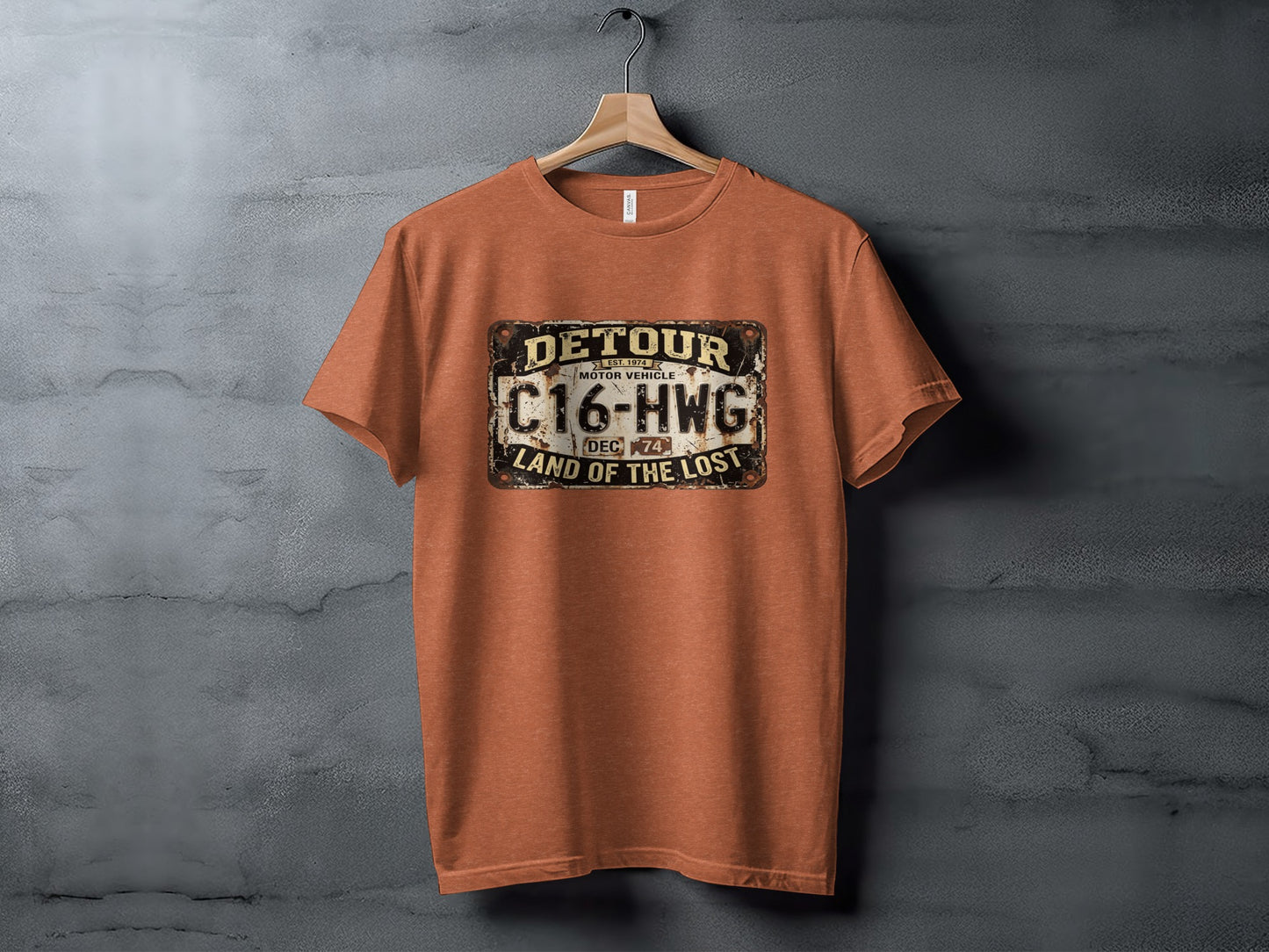 Detour 'Land of the Lost' Vintage | Vintage Outdoor Apparel: Orange t-shirt with "DETOUR C16-HWG LAND OF THE LOST" license plate graphic.