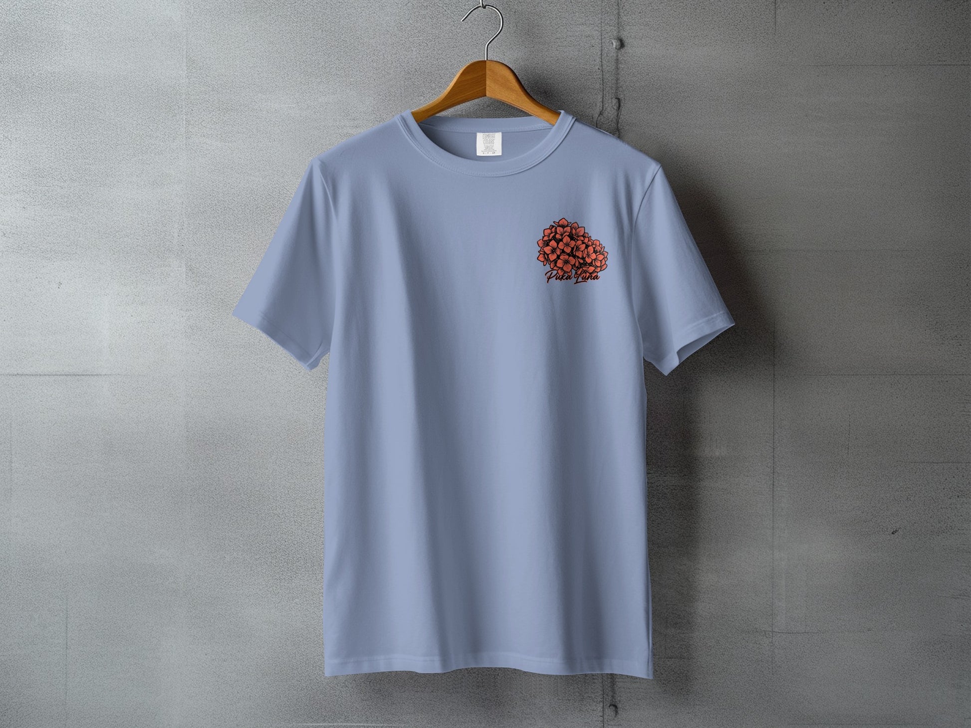 Light blue t-shirt with orange floral graphic and "Pipa Pipa" text on chest.
