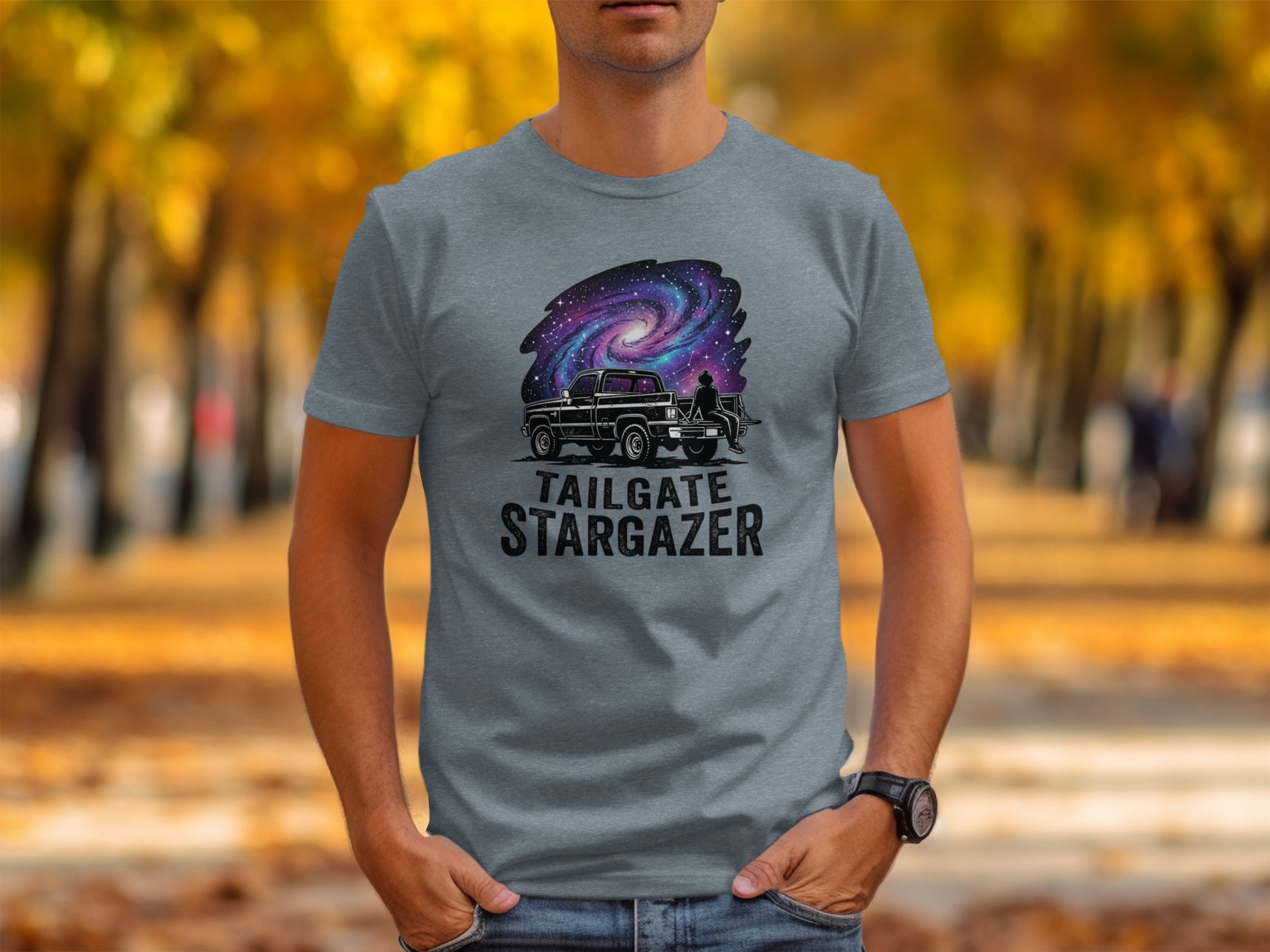 Heritage Cosmic Tailgate Stargazer Nomad Tee: Grey t-shirt with "TAILGATE STARGAZER" text and galaxy-themed truck graphic.