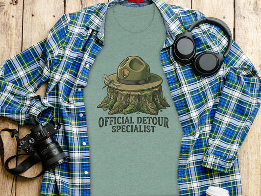 Official Detour Specialist Heritage | Vintage Outdoor Apparel: Green t-shirt with ranger hat on stump illustration and text "Official Detour Specialist."