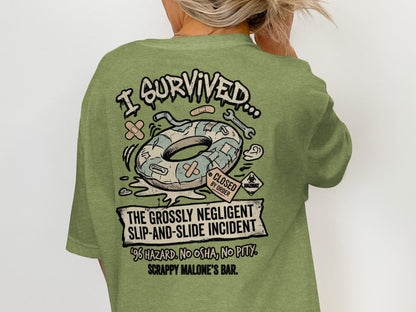 Green t-shirt graphic: "I Survived... The Grossly Negligent Slip-and-Slide Incident"