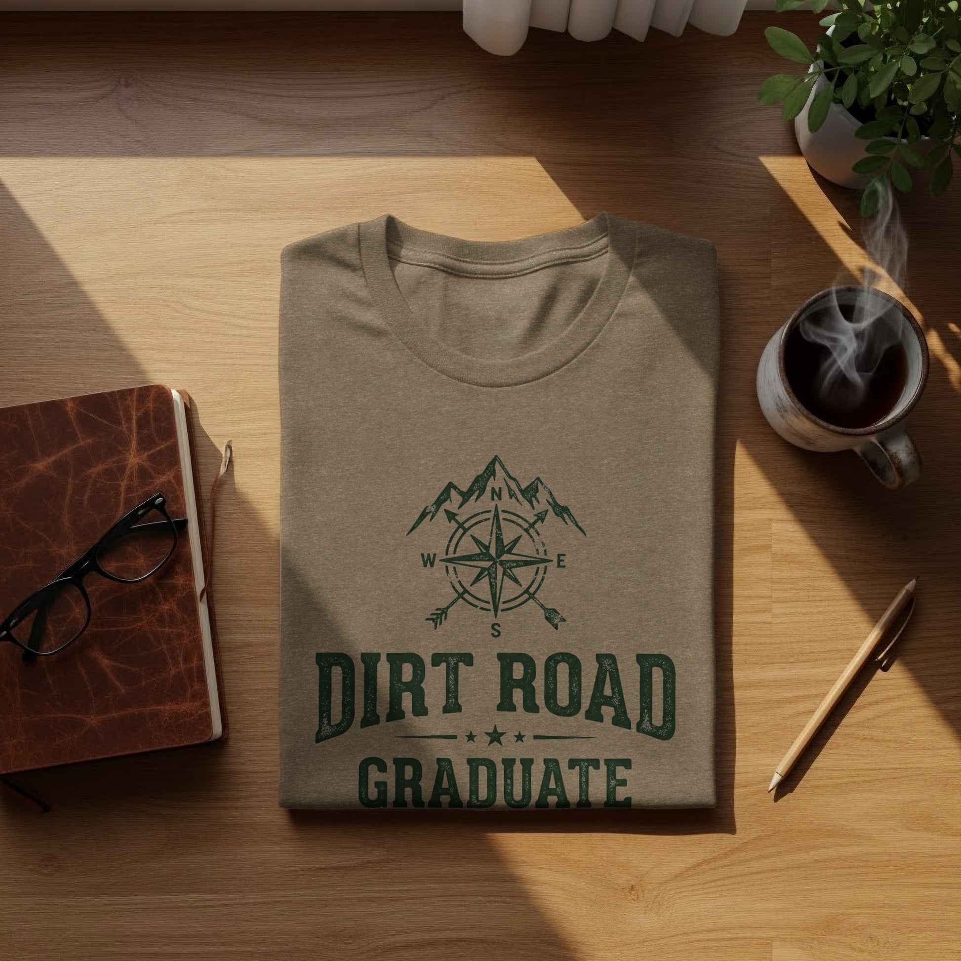 The Original Dirt Road Graduate Outdoor Adventure Top: Brown t-shirt with "Dirt Road Graduate" and compass design.