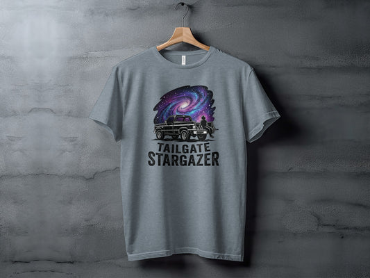 Heritage Cosmic Tailgate Stargazer Nomad Tee: T-shirt graphic of a truck under a galaxy with "Tailgate Stargazer" text.