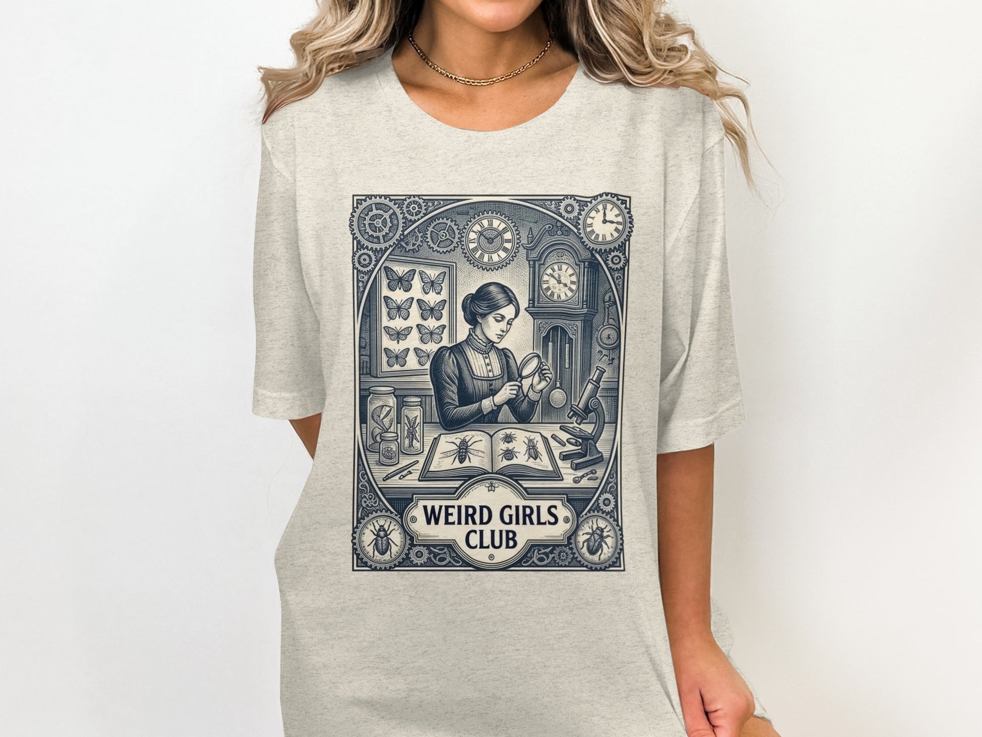 Woman wearing t-shirt with "Weird Girls Club" and illustration of woman with microscope.