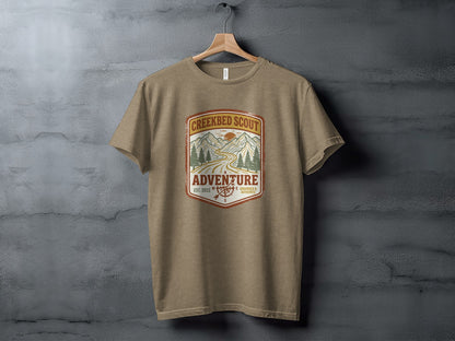 Rugged Creekbed Scout Adventure Emblem Wilderness Shirt: Creekbed Scout Adventure t-shirt with mountain and road graphic.
