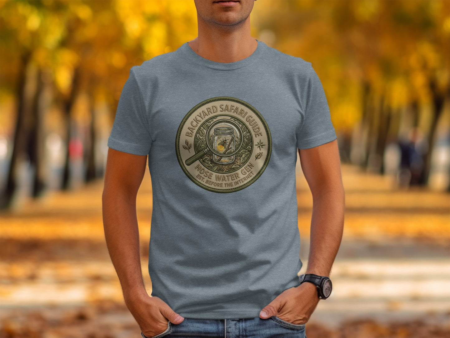 Backyard Safari Guide Explorer: Backcountry Outpost Shirt: Gray t-shirt with "Backyard Safari Guide - Hose Water Gin" badge logo.