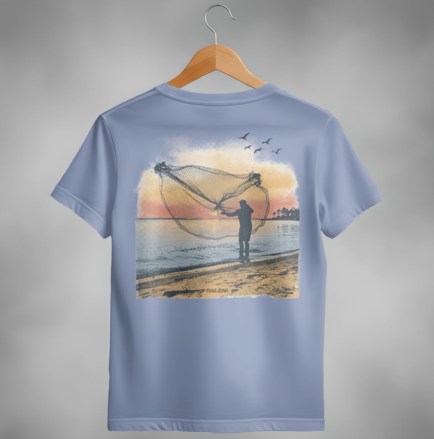 Fisherman casting a net on the beach at sunset with birds flying.