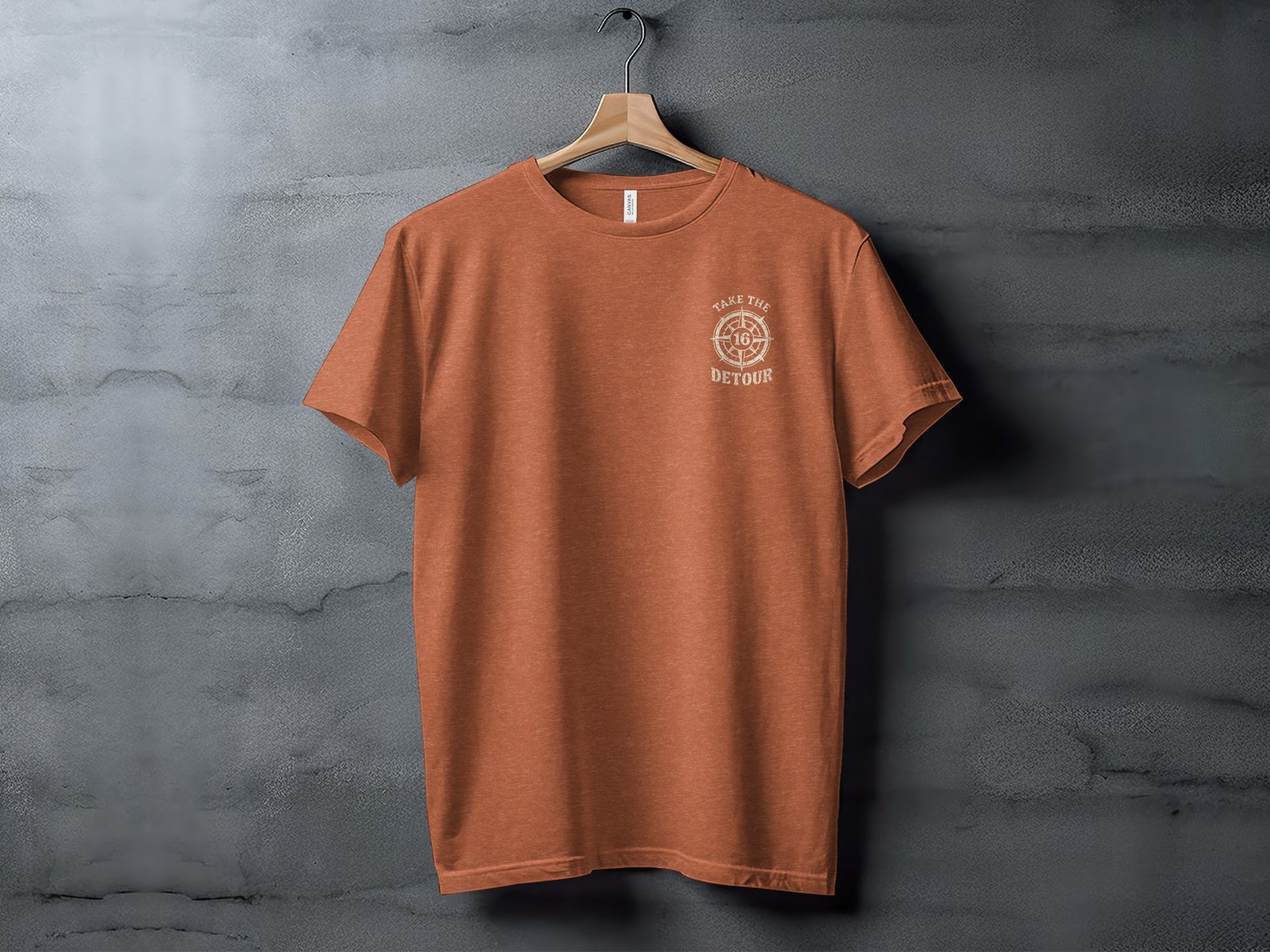 Orange t-shirt with "TAKE THE DETOUR" compass logo on chest.