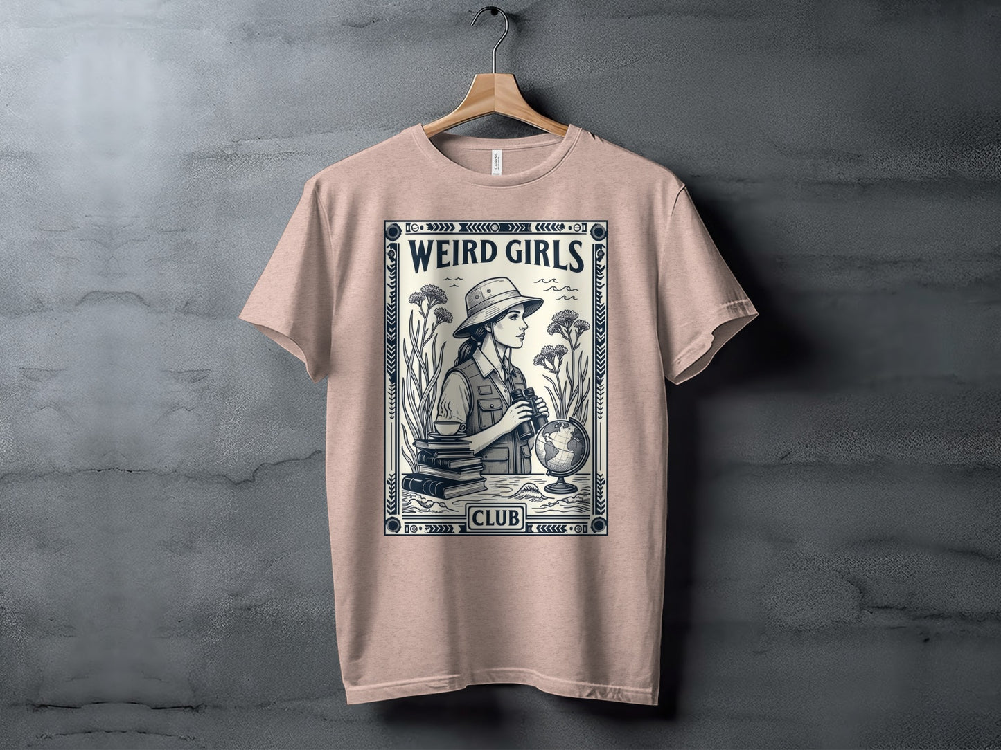 T-shirt graphic with "Weird Girls Club" text, woman with binoculars, books, and globe.