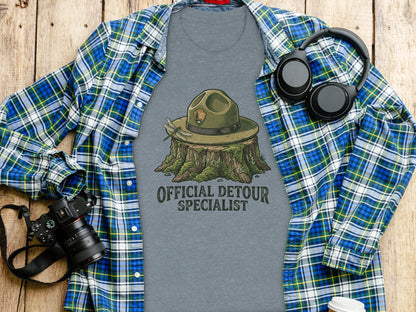 Official Detour Specialist Heritage | Vintage Outdoor Apparel: T-shirt with park ranger hat on stump, dragonfly, and text.