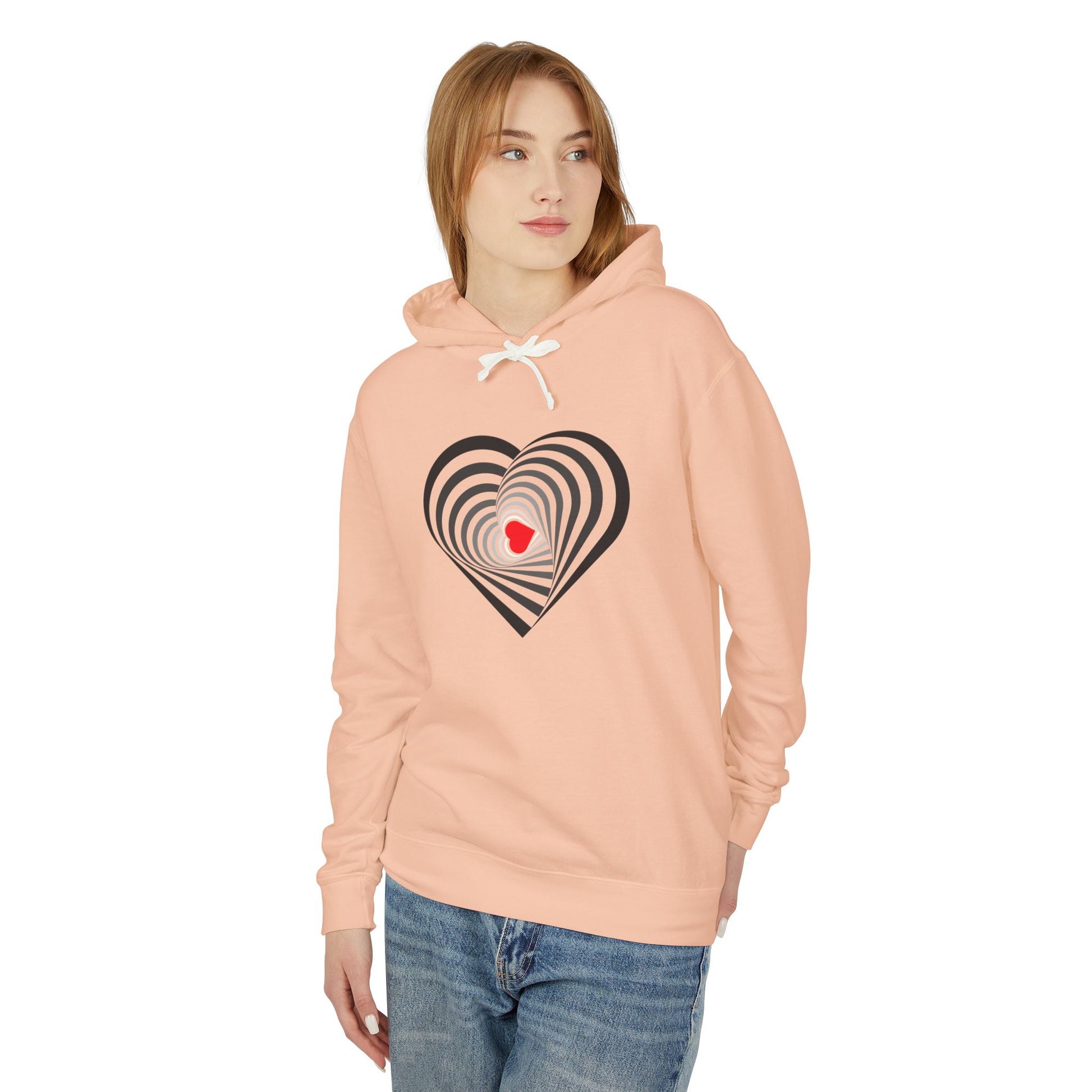 Woman wearing a peach hoodie with a heart design on a white background
