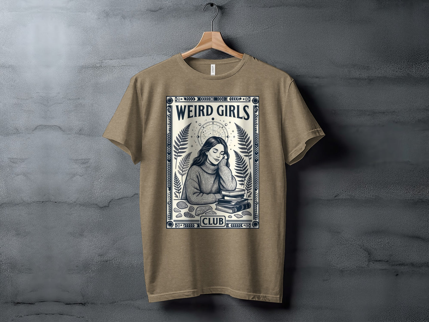 T-shirt featuring "Weird Girls Club" text and woman reading surrounded by foliage.