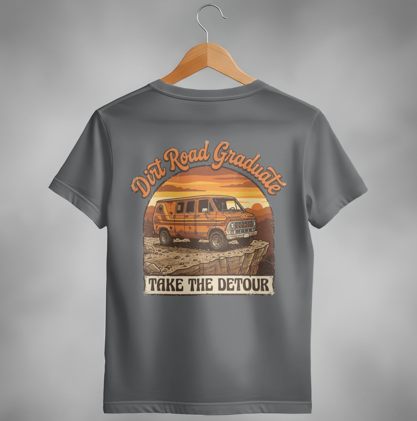 Orange van on rocky terrain with "Dirt Road Graduate Take The Detour" text.