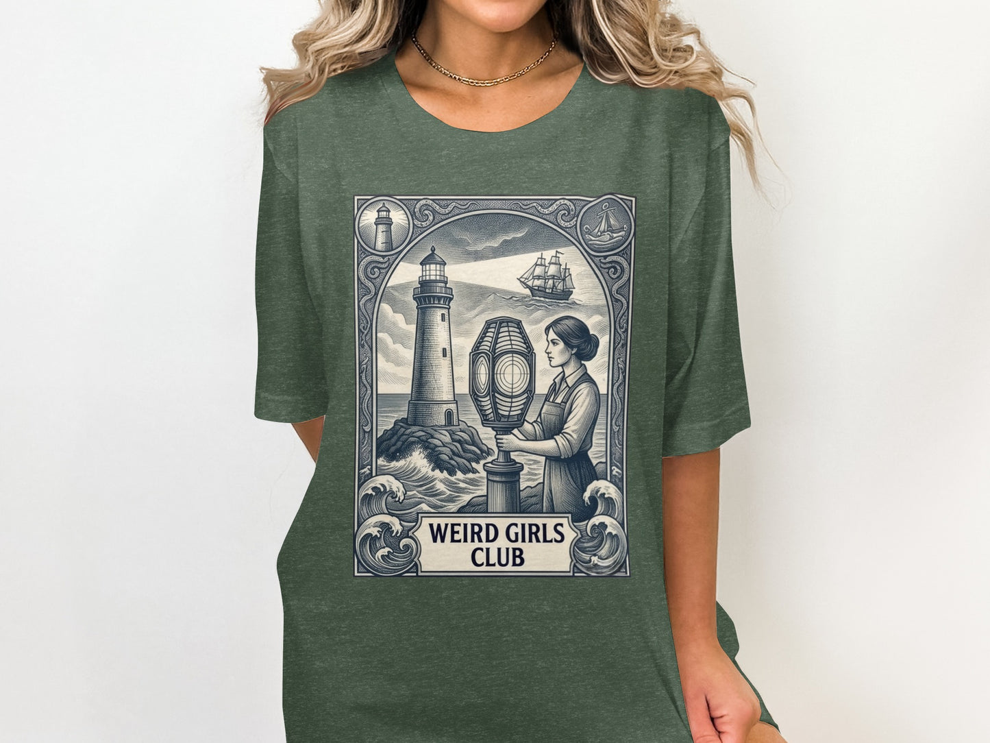 Green t-shirt with "Weird Girls Club" and a lighthouse, ship, and woman illustration.