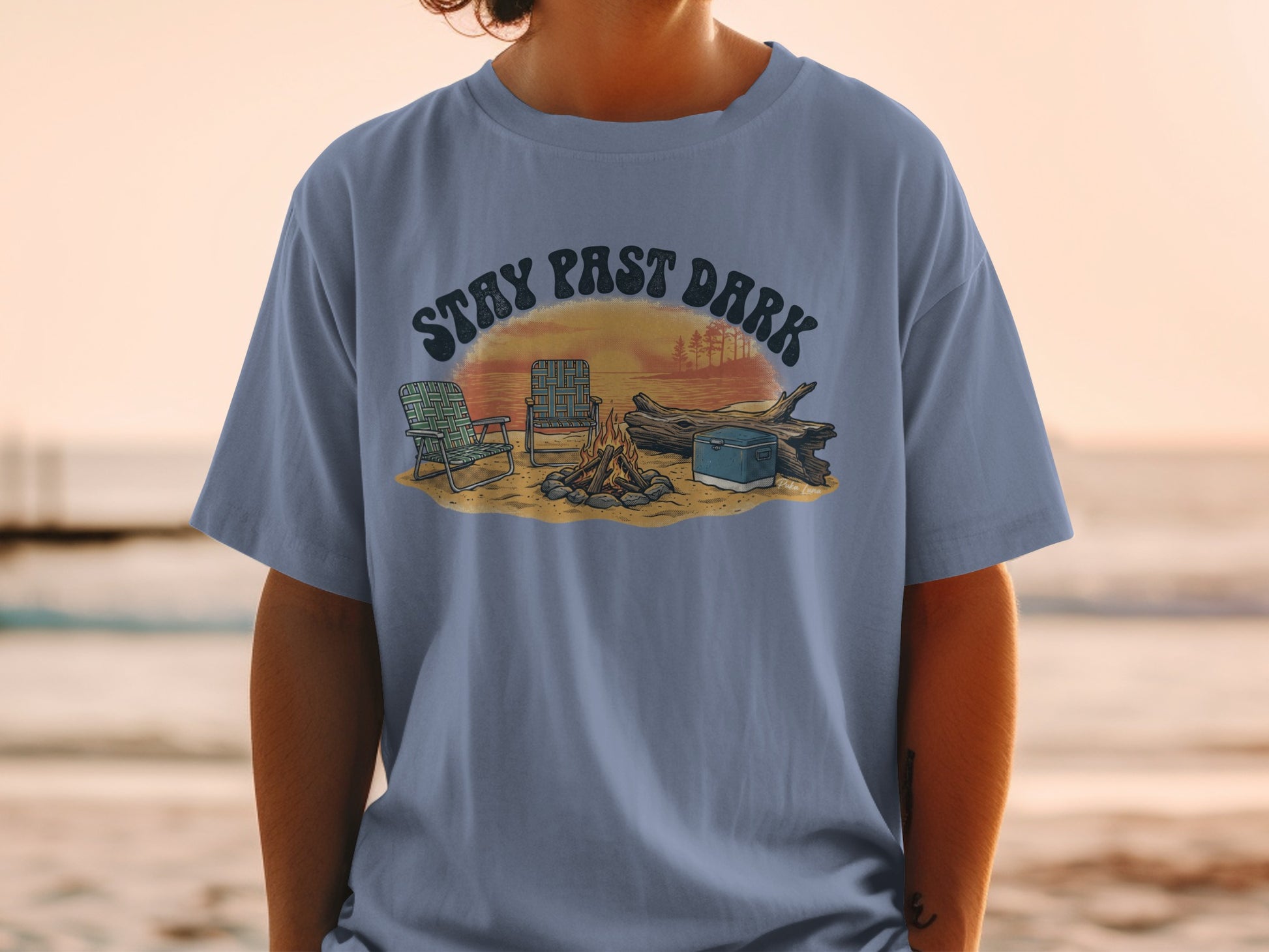 T-shirt with campfire scene, chairs, and "STAY PAST DARK" text.