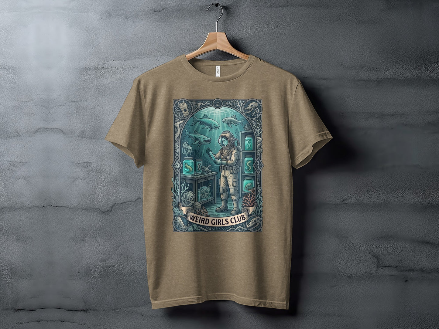 T-shirt graphic of an astronaut in a sunken laboratory with the text "Weird Girls Club."
