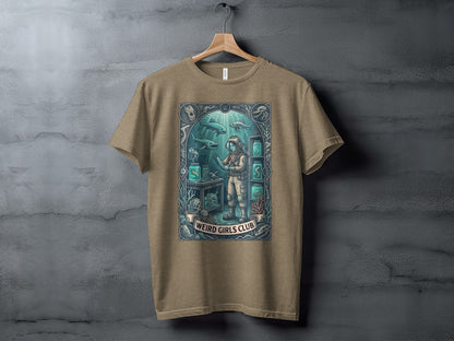 T-shirt graphic of an astronaut in a sunken laboratory with the text "Weird Girls Club."