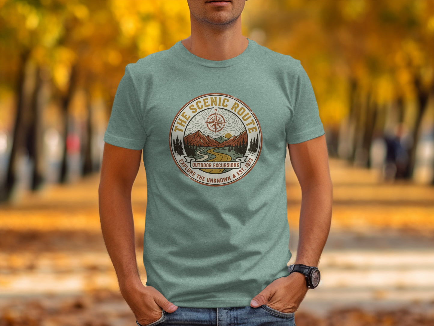 Heritage Scenic Route Vintage Explorer Tee Nomad Tee: Green t-shirt with "The Scenic Route" circular logo featuring mountains and trees.