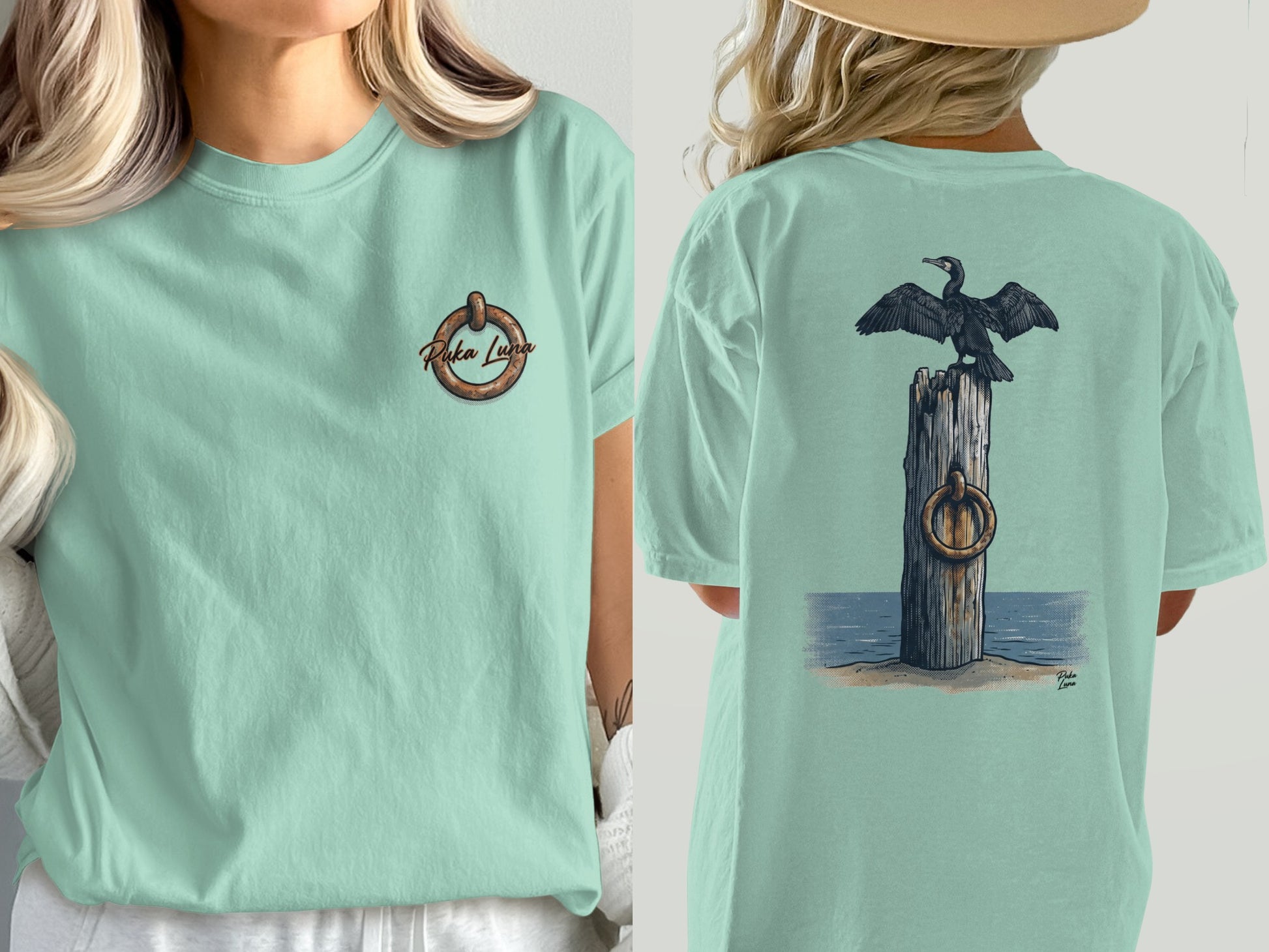 Mint green t-shirt with a cormorant on a post and "Puka Luna" logo.