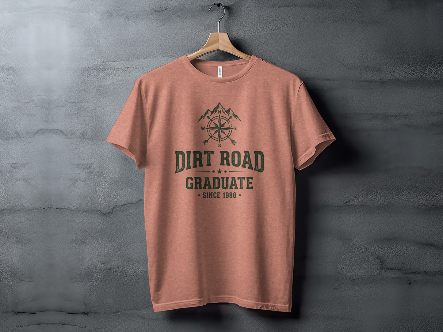 The Original Dirt Road Graduate Outdoor Adventure Top: Peach t-shirt with "Dirt Road Graduate Since 1988" text and compass graphic.