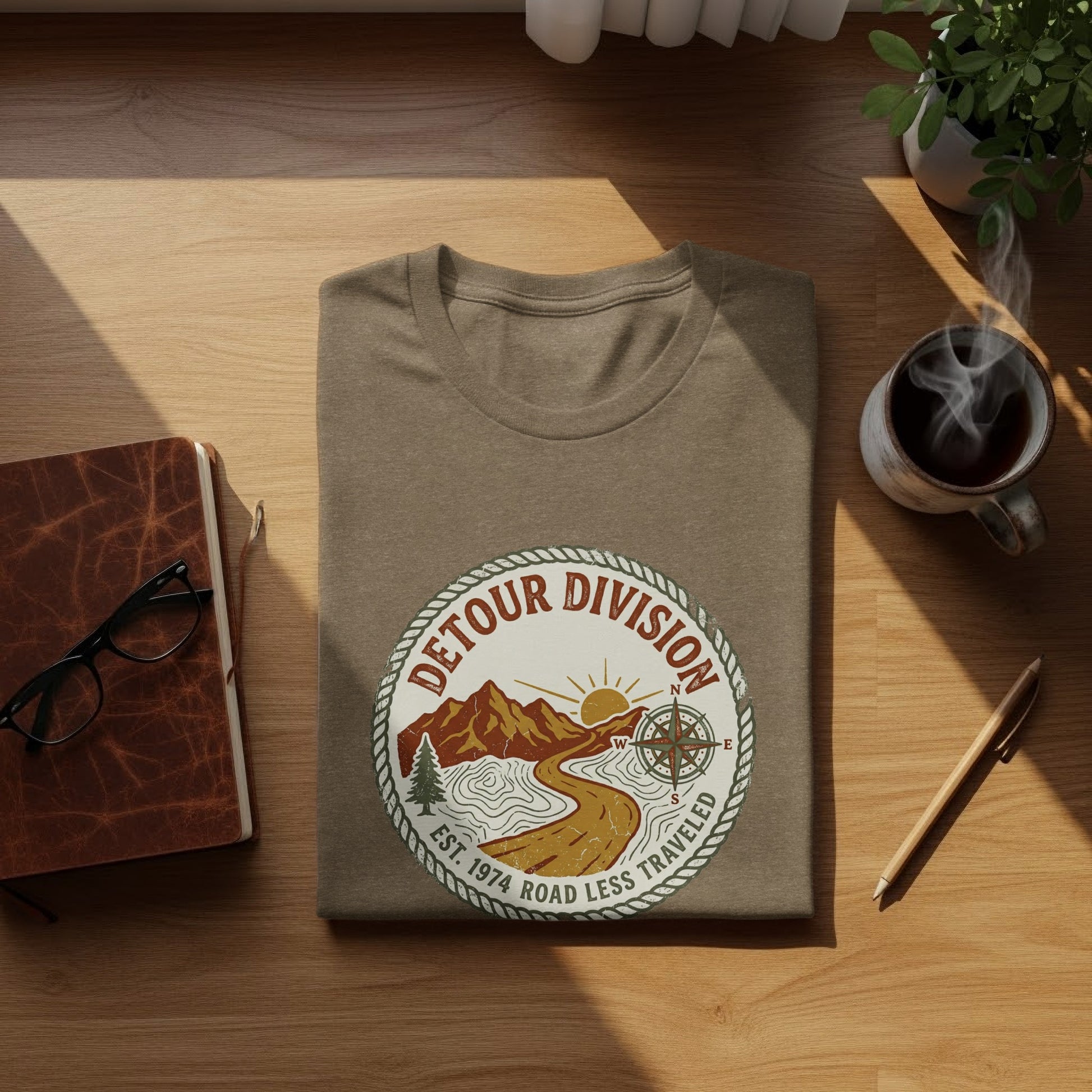 Detour Division Heritage | Vintage Outdoor Apparel: Brown t-shirt with circular "Detour Division" logo featuring mountains and compass.