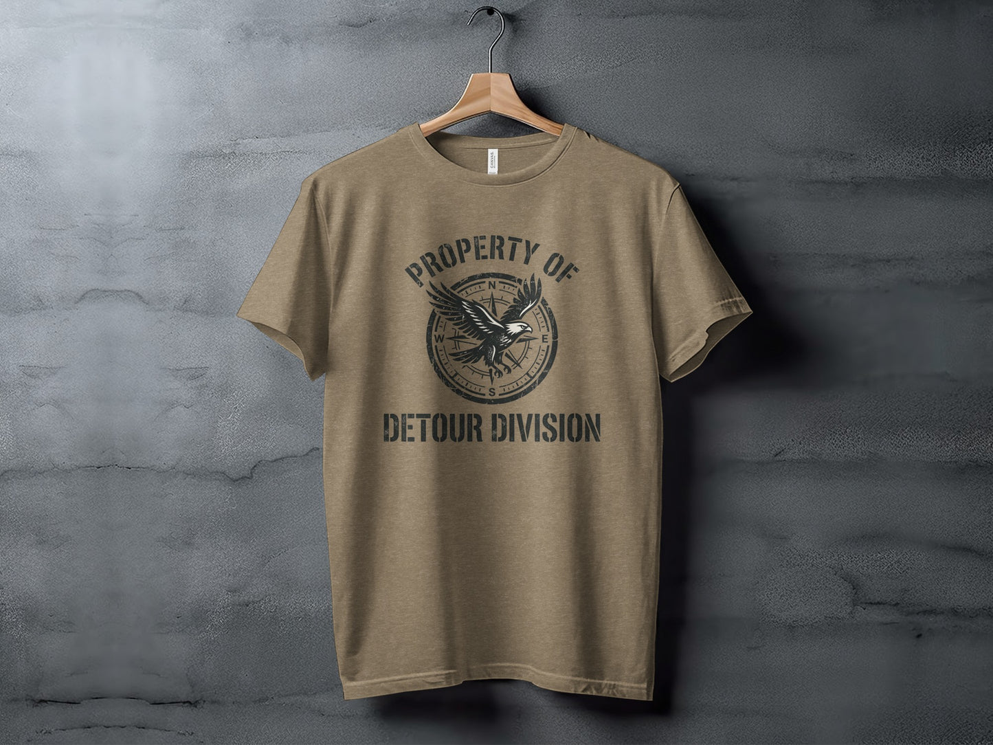Rugged Detour Division Compass Eagle Tee Wilderness Shirt: Brown t-shirt with "PROPERTY OF DETOUR DIVISION" and compass graphic.