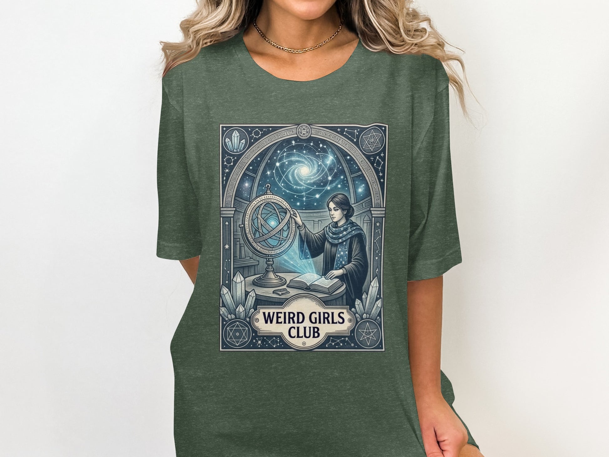 T-shirt graphic with woman and globe under starry archway, "Weird Girls Club."