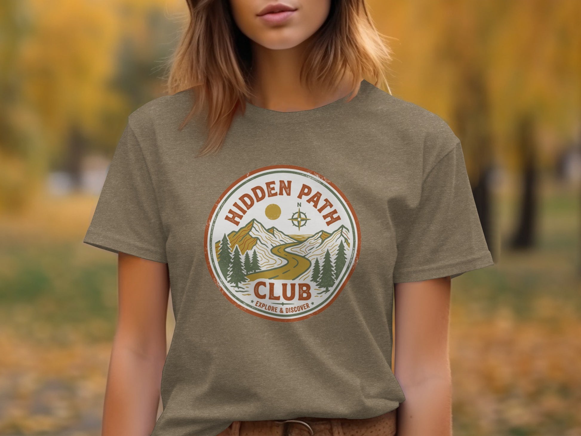 Rugged Hidden Path Club Explorer Wilderness Shirt: T-shirt with a circular "Hidden Path Club" logo featuring mountains and trees.