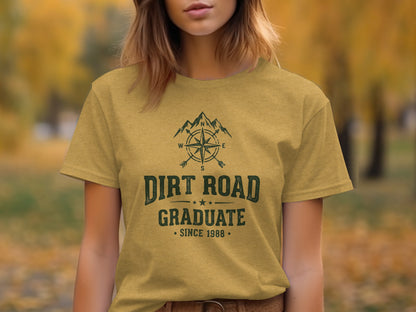 The Original Dirt Road Graduate Outdoor Adventure Top: T-shirt with "Dirt Road Graduate" text, compass, and mountain graphic.