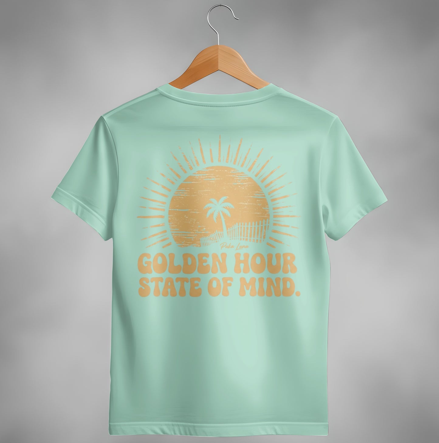 Mint t-shirt with "Golden Hour State of Mind" text and a sunset graphic.