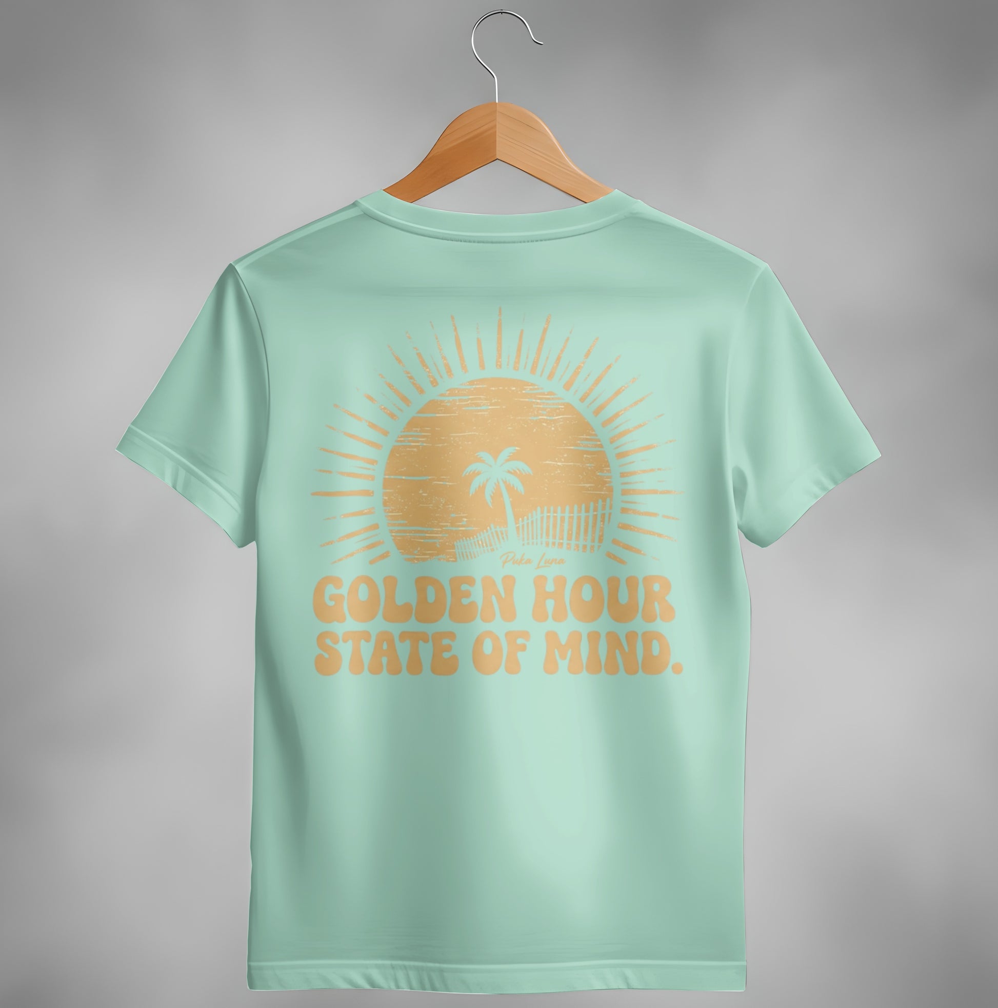 Mint t-shirt with "Golden Hour State of Mind" text and a sunset graphic.