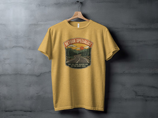 Heritage Detour Specialist Vintage Graphic Nomad Tee: Yellow t-shirt with "Detour Specialist" text and mountain landscape graphic.