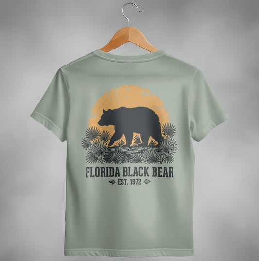 Black bear silhouette walking towards a setting sun with "Florida Black Bear Est. 1972".