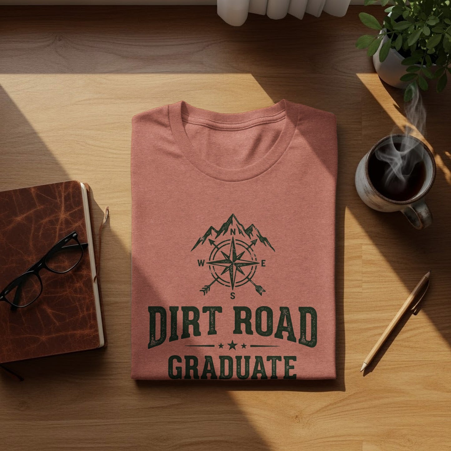 The Original Dirt Road Graduate Outdoor Adventure Top: Terracotta t-shirt with "Dirt Road Graduate" text and compass graphic.