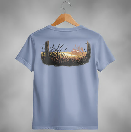 T-shirt with a sunset scene featuring a boat in the distance and tall grass.