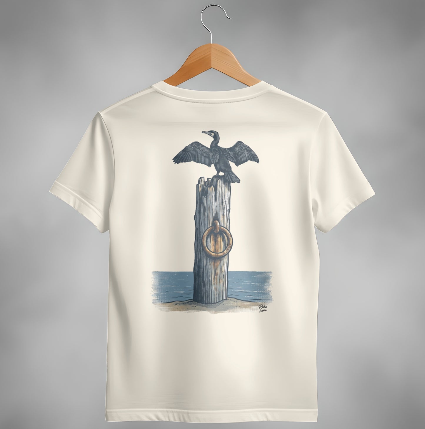 Cream t-shirt with a cormorant perched on a pilothouse with a ring.