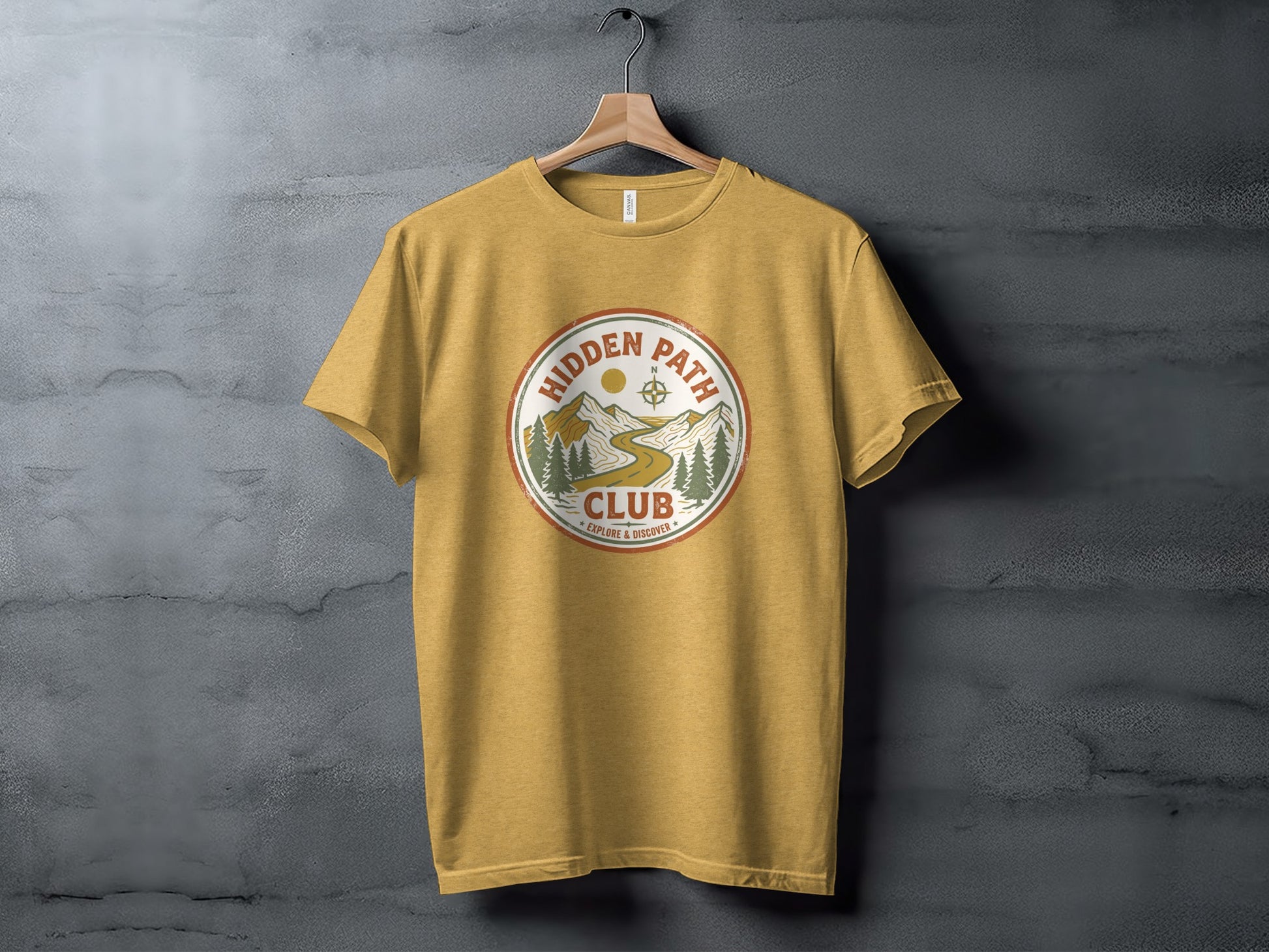 Rugged Hidden Path Club Explorer Wilderness Shirt: Yellow t-shirt featuring "Hidden Path Club" logo with mountain and compass graphics.