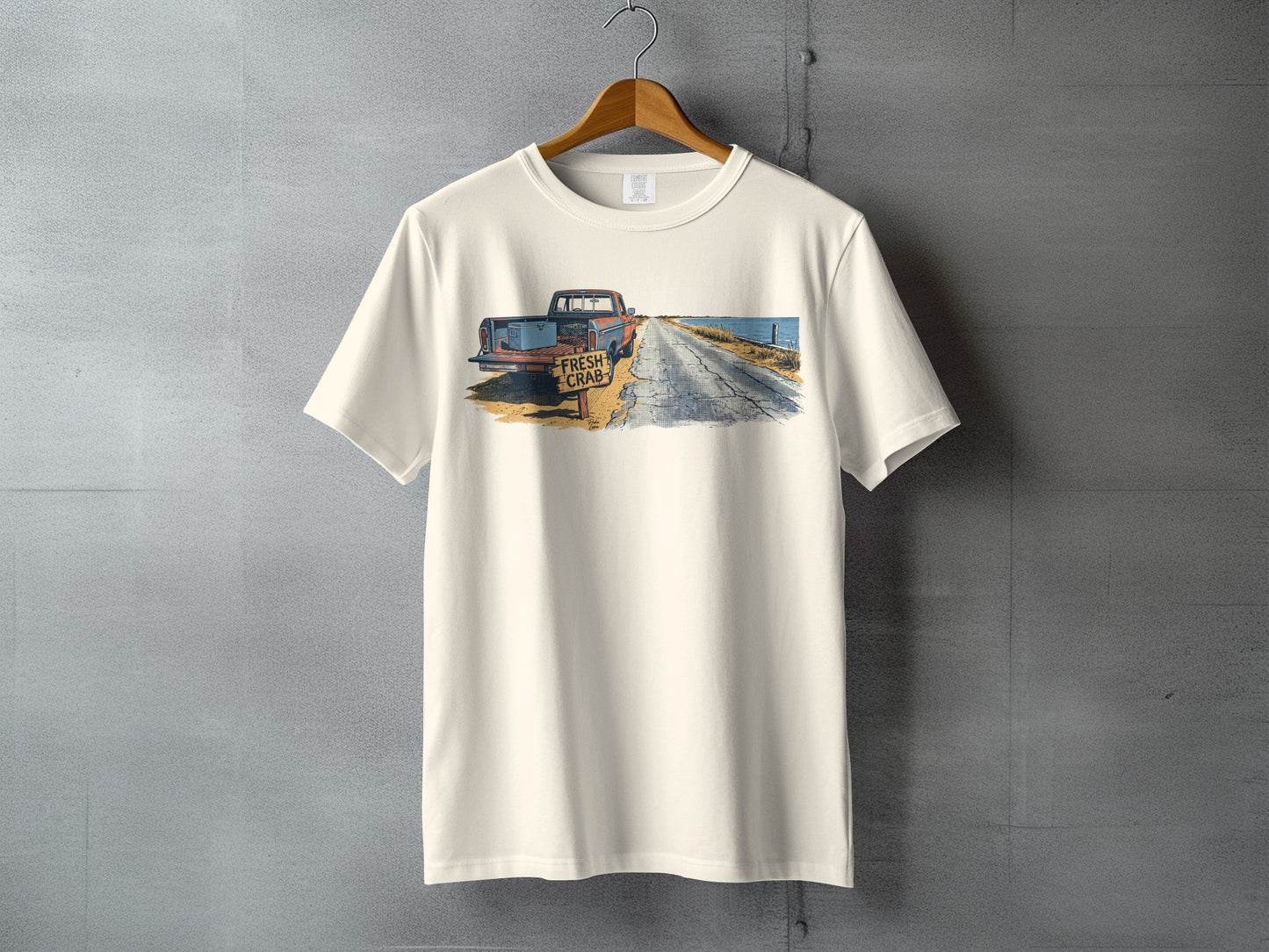 T-shirt with illustration of antique truck and "FRESH CRAB" sign by a road.
