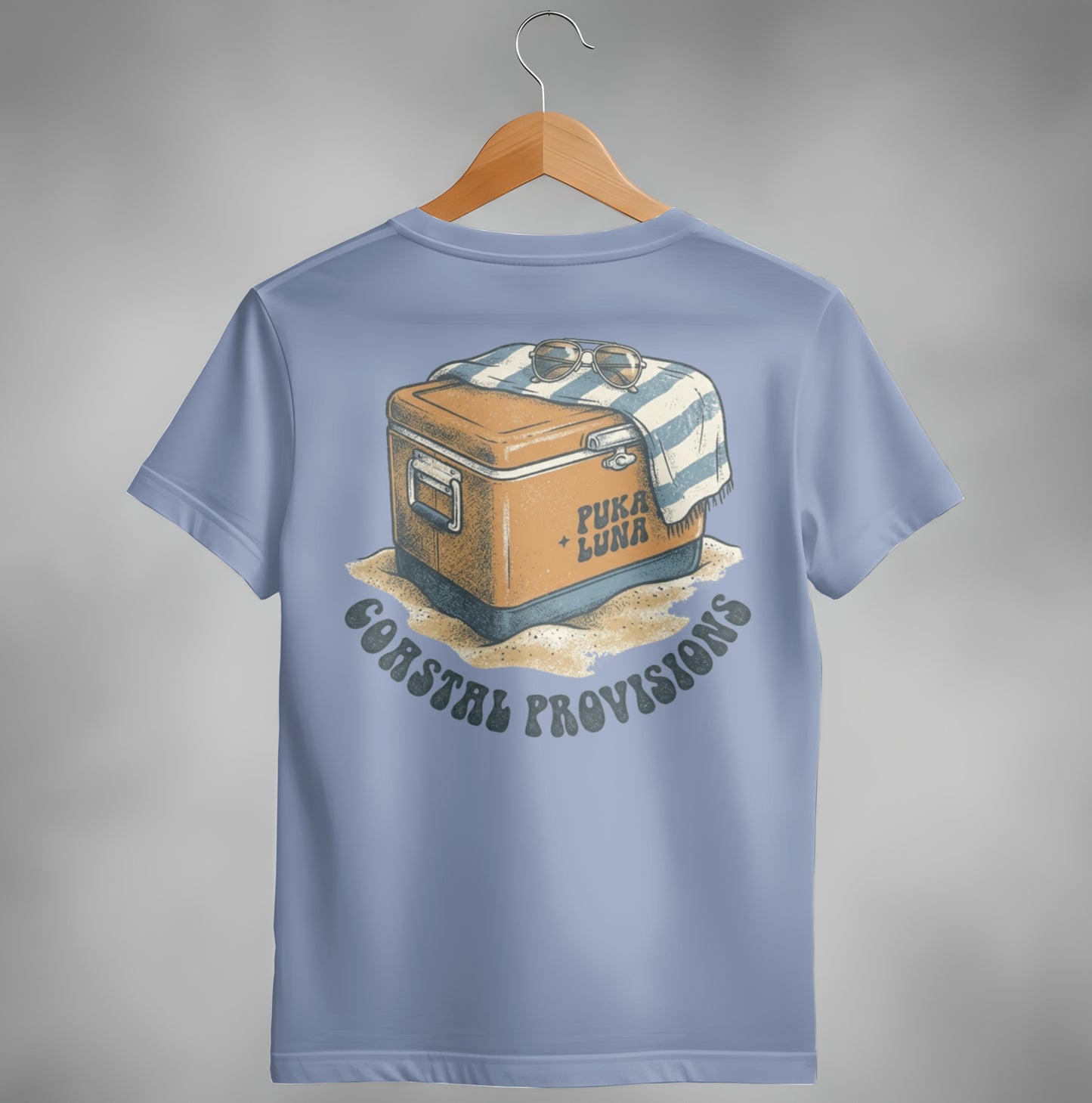 Coastal Provisions t-shirt graphic: cooler with sunglasses on a beach towel.