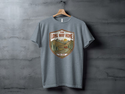 Rugged The Long Way Home | Vintage Adventure Wilderness Shirt: Grey t-shirt with a distressed shield graphic featuring a sun, mountains, and a car.