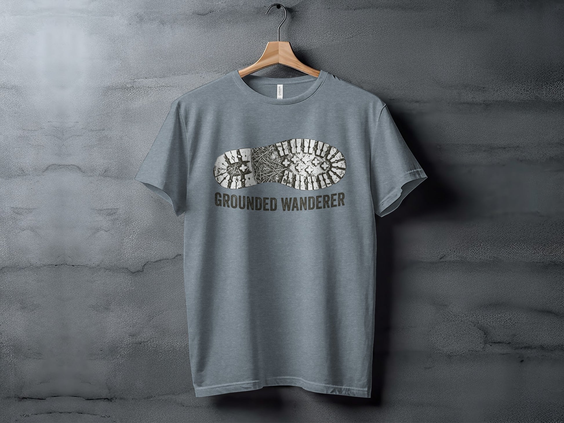 Grounded Wanderer Boot Print | Vintage Outdoor Apparel: Gray t-shirt with a boot print and "GROUNDED WANDERER" text.