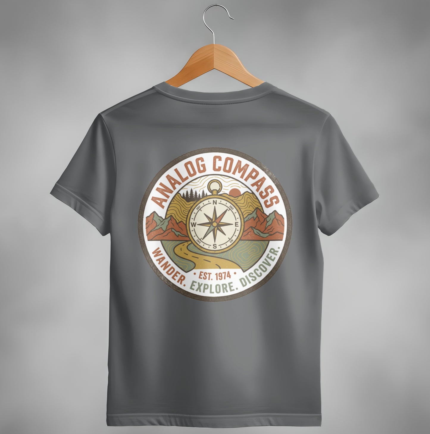 Gray t-shirt with a round "Analog Compass" graphic: Wander. Explore. Discover. Est. 1974.