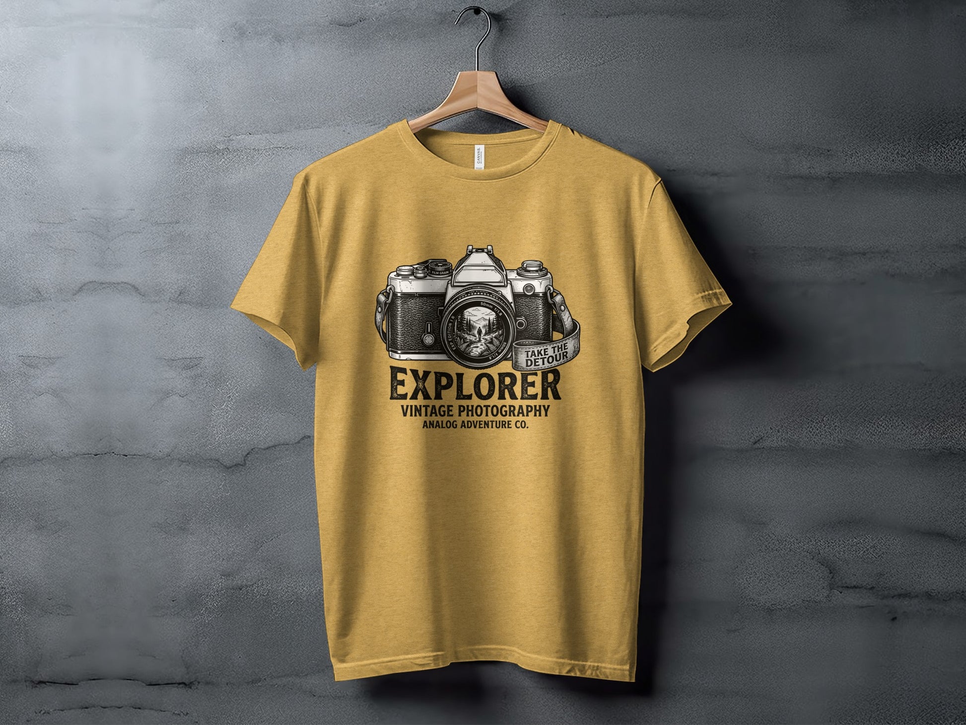 The Analog Explorer's Detour: Backcountry Outpost Shirt: Yellow t-shirt with vintage camera graphic and "Explorer" text.