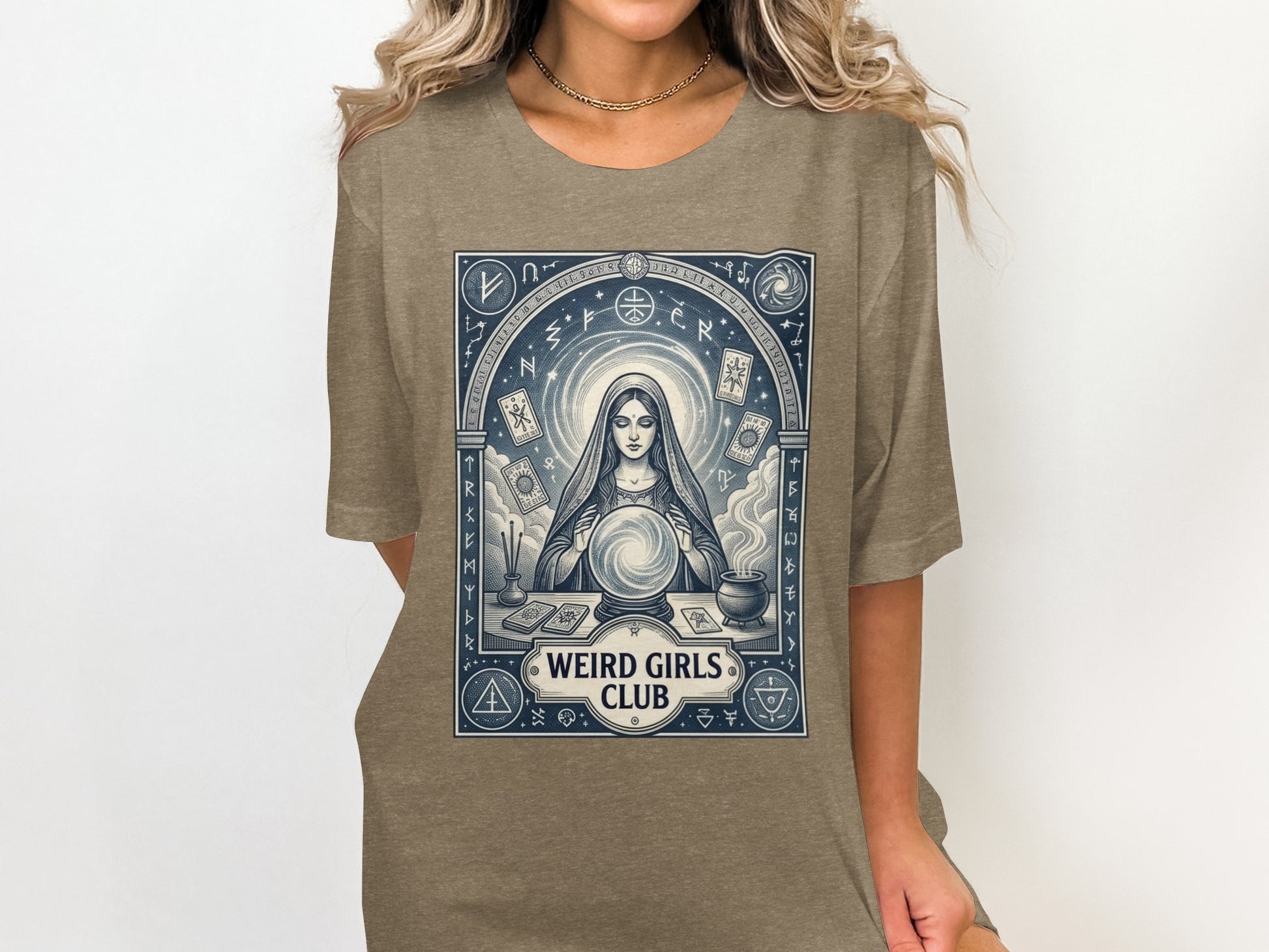T-shirt with mystical woman, crystal ball, celestial symbols, and "WEIRD GIRLS CLUB" text.