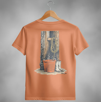 Orange t-shirt with illustration of a bucket, boots, and rope on a wooden post.
