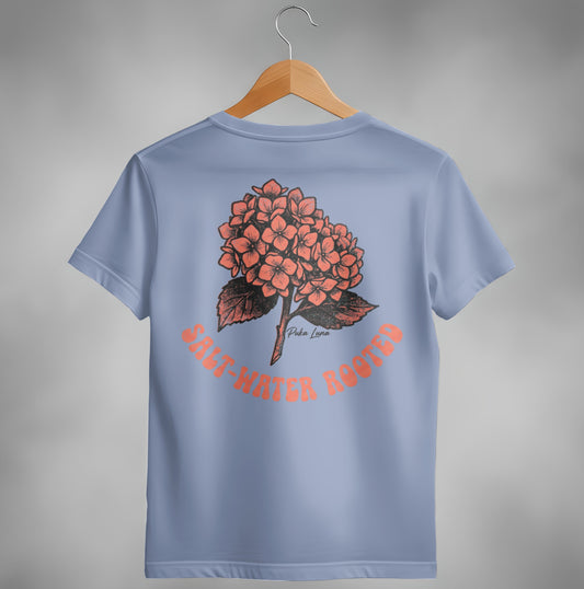 Blue t-shirt with coral hydrangea illustration and text "SALT-WATER ROOTED".